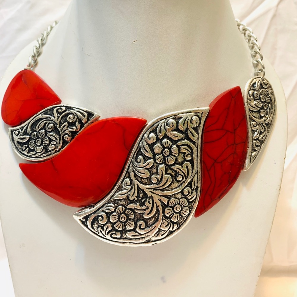 Coral color choker necklace.
